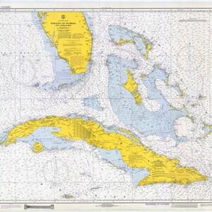 May include: A nautical chart of the Straits of Florida and Approaches, showing the coastline of Florida and Cuba. The chart is printed in blue and yellow, with soundings in fathoms.