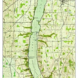May include: A vintage map of Lake Conesus, New York, from 1942. The map shows the lake, surrounding roads, and topographical features. The map is in shades of green, brown, and black.