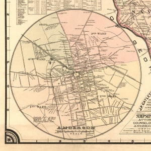 May include: A vintage map of Anderson, South Carolina, showing the city's layout with street names and ward boundaries. The map is in a circular format with a scale in miles. The map is printed on a cream-colored paper with brown and black ink.