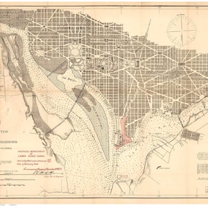 May include: A vintage map of Washington, D.C. and Georgetown, showing the city's layout and surrounding waterways. The map is printed in black and white with red accents, and includes a compass rose and a scale bar.