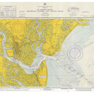 May include: A nautical chart of St. Simons Sound, Brunswick Harbor, and Turtle River in Georgia. The chart shows the waterways, islands, and depths of the area. The chart is in black and white with yellow and blue markings.