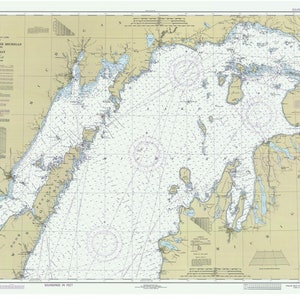 May include: A detailed nautical chart of the North End of Lake Michigan, Green Bay, with depth soundings in feet. The chart features coastlines, islands, and navigational markers, with text indicating locations and geographical features. The map is in shades of blue, tan, and white.