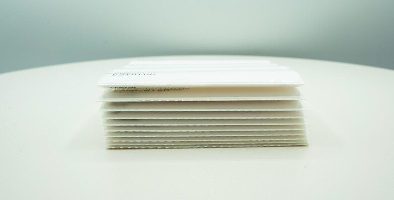 May include: A stack of white paper cards, each with a subtle texture. The top card has the word "EXTEND" printed on it.