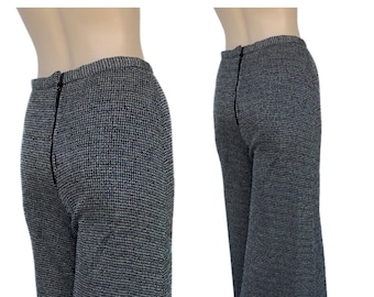 May include: Black and white patterned pants with a wide leg silhouette. The pants have a zipper closure in the back.