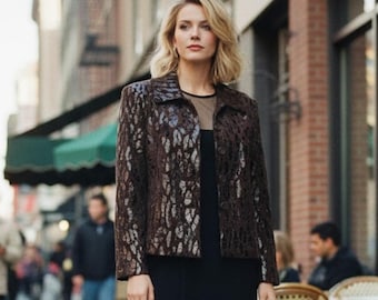 May include: A dark brown jacket featuring a textured, metallic silver animal print pattern, a classic collar, and a button-front closure, worn over a simple black top. The jacket has long sleeves and a structured fit, providing a distinct contrast.