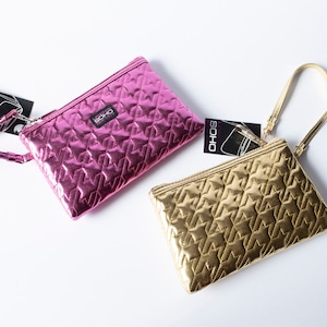 May include: Two quilted metallic clutches with a star pattern. One is pink and the other is gold. Both have a zipper closure and a wrist strap.