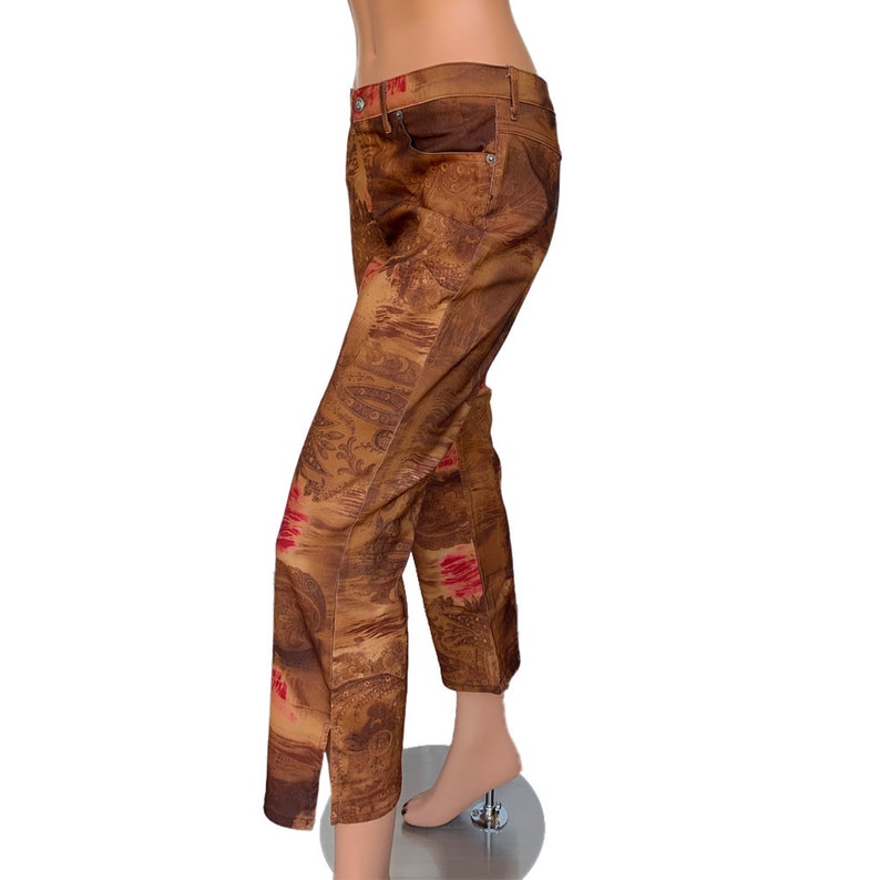 May include: Brown pants with a red and brown patterned design. The pants have a straight leg and a relaxed fit.