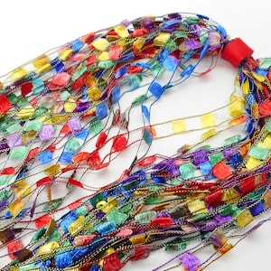 May include: A multi-coloured yarn with a variety of colours, including red, yellow, blue, green, and purple. The yarn is made of a soft, silky material and has a delicate, shimmering finish.