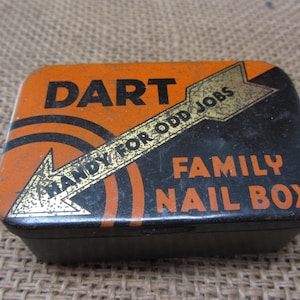May include: A vintage metal box for nails, with an orange and black design. The box has the text "DART HANDY FOR ODD JOBS FAMILY NAIL BOX" printed on it.