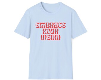 May include: A pale blue t-shirt featuring the red text "EMBRACE YOUR WEIRD" in a retro style. The short-sleeved top is made of a soft fabric and is suitable for casual wear.