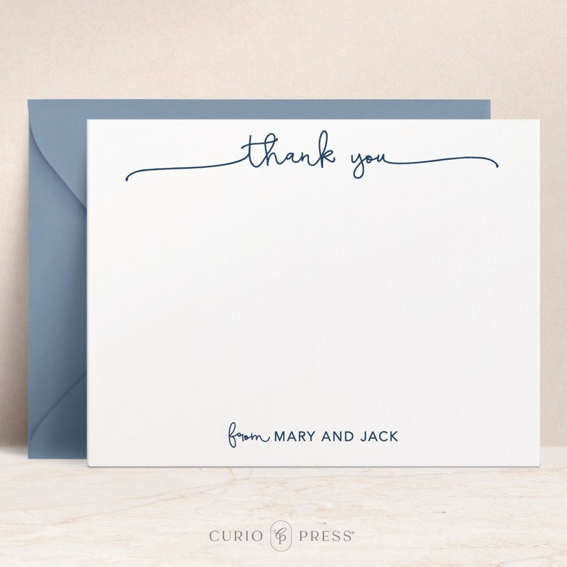 May include: A white thank you card with a handwritten script that says "thank you" with a line underneath. The card also has the text "from MARY AND JACK" in a smaller font.