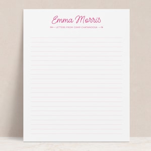 May include: A white lined notepad with the name "Emma Morris" in pink script at the top, along with the text "Letters from Camp Chattanooga". The notepad has horizontal pink lines.