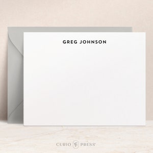 May include: White stationery card with a gray envelope. The card has the name "GREG JOHNSON" printed in black at the top.