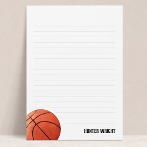 May include: Personalized lined paper with a basketball graphic and the name "HUNTER WRIGHT" at the bottom.