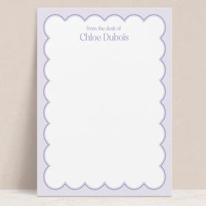 May include: A light purple stationery card with a scalloped border. The text "from the desk of Chloe Dubois" is printed in the top center of the card.