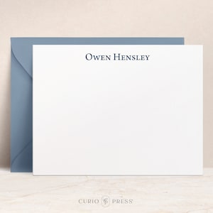 May include: A white stationery card with a blue envelope. The card has the name "Owen Hensley" printed in blue at the top.
