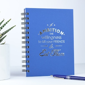 Ambition. The willingness to kill your friends and eat them. Foil Pressed Journal.