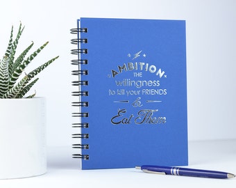 Ambition. The willingness to kill your friends and eat them. Foil Pressed Journal.