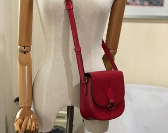 Sold at Auction: Louis Vuitton Red Epi Saint Cloud PM Bag with red  stitching and brass hardware, opening to a black leather interior with  pocket, the strap with adjustable brass belt buckles