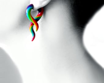 May include: Rainbow colored acrylic ear gauge plugs in a twisted, spiral shape.