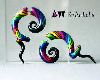 May include: A pair of rainbow colored spiral ear gauges with black spiral ends. The gauges are made of polymer clay and are approximately 1.5 inches long.