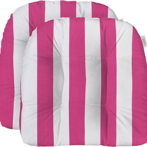 May include: Two pink and white striped outdoor chair cushions. The cushions have a button tuft in the center and are made of a soft, durable fabric.