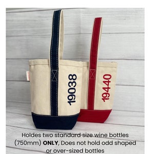 May include: Two canvas wine totes with navy blue and red handles. The totes are personalized with the numbers "19038" and "19440". The totes are designed to hold two standard size wine bottles (750ml) ONLY.  The totes are not designed to hold odd shaped or over-sized bottles.