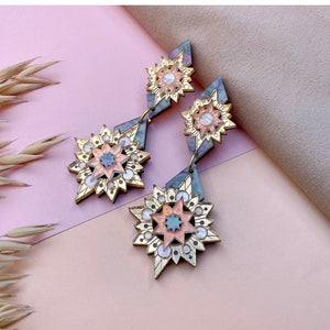 Laser cut large star statement earrings in gold, iridescent, pearl and blue marble.
