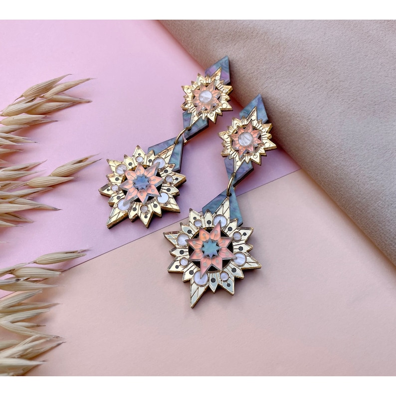 Laser cut large star statement earrings in gold, iridescent, pearl and blue marble.