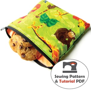 May include: A green zippered pouch with a colorful animal print featuring giraffes, monkeys, and other jungle animals. The pouch is open and filled with chocolate chip cookies. The image includes the text "Sewing Pattern & Tutorial PDF".
