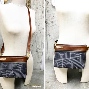 May include: Two views of a brown leather and black fabric crossbody bag with a geometric pattern. The bag has a gold metal buckle and a gold metal name tag that reads "MOLATO".