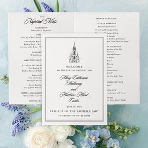May include: Wedding ceremony program with the text "The Nuptial Mass" and the names Mary Catherine Halloway and Matthew Mark Curtis. The program includes the date June 20, 2026, and the Basilica of the Sacred Heart, University of Notre Dame.