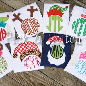 May include: Eight white t-shirts with different Christmas-themed designs featuring a monogram in a circle. The designs include a reindeer, a Santa, an elf, and an ornament. The text "Pick & Stitch" is visible in the center of the image.