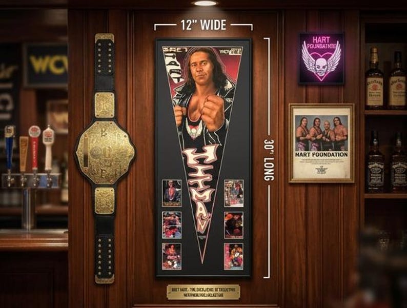 May include: A framed image of a wrestler, 30 inches long and 12 inches wide, with a championship belt and other memorabilia. The image features a wrestler in a black and white outfit. A neon sign and a framed photo are also visible.
