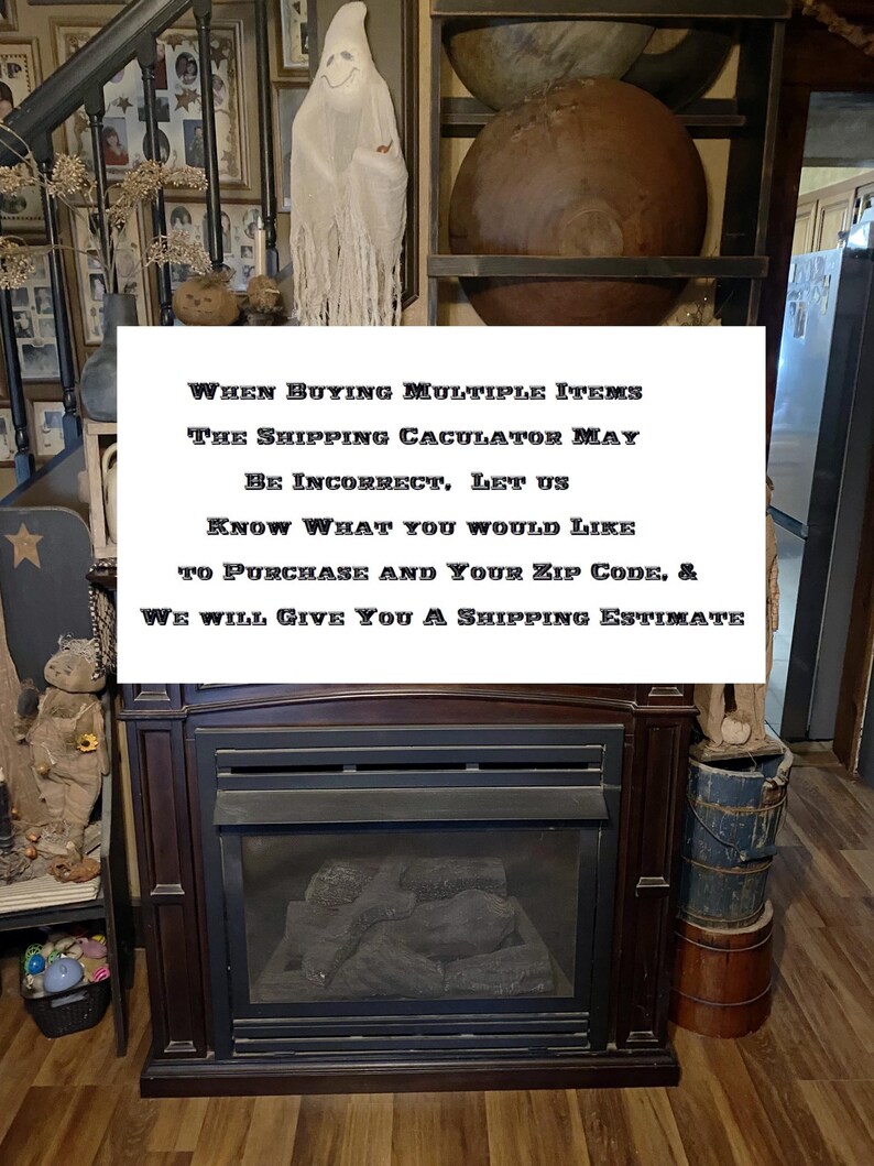 May include: A sign with the text "WHEN BUYING MULTIPLE ITEMS THE SHIPPING CALCULATOR MAY BE INCORRECT, LET US KNOW WHAT YOU WOULD LIKE TO PURCHASE AND YOUR ZIP CODE, & WE WILL GIVE YOU A SHIPPING ESTIMATE". The sign is in front of a fireplace with a ghost figurine and other decorative items.