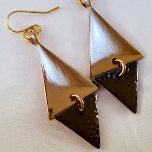 Gold and black geometric dangle earrings.