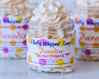 May include: A clear jar filled with fluffy, whipped soap, topped with a swirl of light beige soap. The jar has a label that reads "Fluffy Whipped Soap Paradise" with the brand name "Xplosive Cosmetix". The product is 3.2 oz / 4 oz.