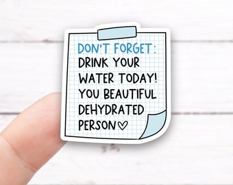 May include: A blue and white sticker with a grid pattern and the text "Don't forget: Drink your water today! You beautiful dehydrated person ♥".