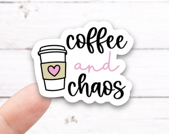 May include: White sticker with a black coffee cup with a pink heart and the text "coffee and chaos" in black.