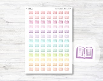 May include: A sheet of colorful book stickers with a rainbow gradient of pink, purple, blue, green, yellow, and orange. The stickers are all the same size and shape, and they feature a simple outline of an open book. The sheet also includes a larger sticker of a purple open book.
