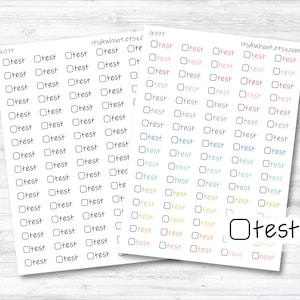 May include: A sheet of printable stickers featuring a selection of checkboxes and the word "test" written in various colours. The stickers are intended for use in planners, journals, and other organisational tools.