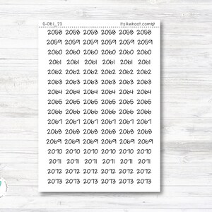 May include: A sheet of white paper with handwritten numbers from 2058 to 2013. The numbers are arranged in rows of six, with each number repeated six times. The text "itsAwhoot.com♡" and "6-061 23" are at the top of the sheet.