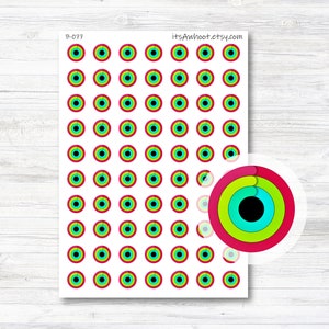 May include: A sheet of 63 colorful circle stickers with a red, green, blue, and black concentric circle design. The stickers are arranged in a grid pattern on a white background. The text "itsAwhoot.etsy.com" is printed in the top right corner of the sheet. The text "B-077" is printed in the top left corner of the sheet.
