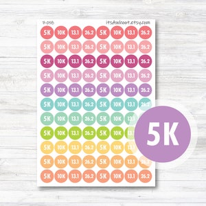 May include: A sheet of colorful round stickers with the text "5K", "10K", "13.1", and "26.2" printed on them. The stickers are arranged in rows and columns, with each row featuring a different color.