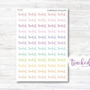May include: A sheet of colorful stickers with the word "tracked" repeated multiple times in different colors. The word "tracked" is also written in a larger size in purple at the bottom right corner of the sheet.