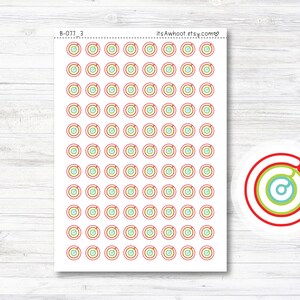 May include: A sheet of 100 colorful circle stickers with a red, yellow, green, and blue concentric circle design. The stickers are arranged in a grid pattern. The text "itsAwhoot.etsy.com" is printed in the top right corner of the sheet. The text "B-077_3" is printed in the top left corner of the sheet.