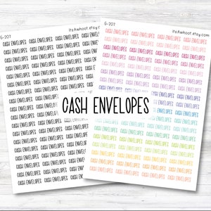 May include: Two sheets of colorful stickers with the text "CASH ENVELOPES" repeated multiple times. The stickers are on a white wooden background.