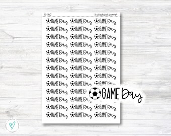May include: A sheet of stickers with the text "GAME DAY" and a soccer ball graphic. The stickers are black and white and are arranged in rows.