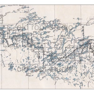 May include: Vintage map print featuring a detailed cartographic representation of a lake region, with numerous blue water bodies and land areas. The map includes numbered grid sections and text labels, all in a muted color palette.