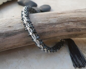 Bracelet: Moonstone and Snowflake Obsidian are hand woven together with Japanese Miyuki Beads, Silver Clasp, Vintage Style with Silk Tassel